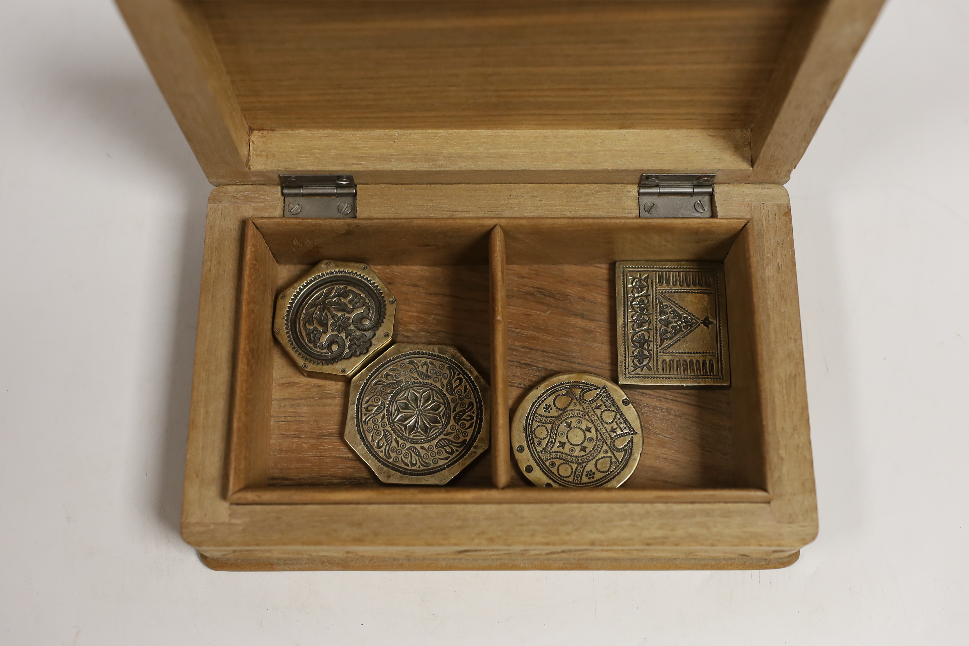 A group of Indian bronze sweet moulds, contained in a carved teak box